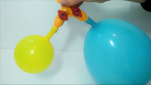 A smaller yellow and a larger blue balloon connected by a hose-connector
